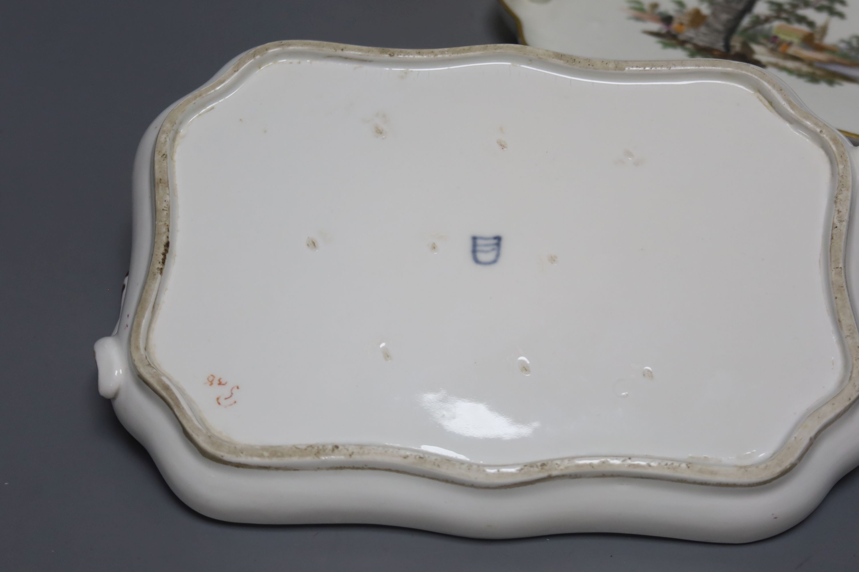 Two 18th century Vienna porcelain trays and a seated figure, largest tray 16cm